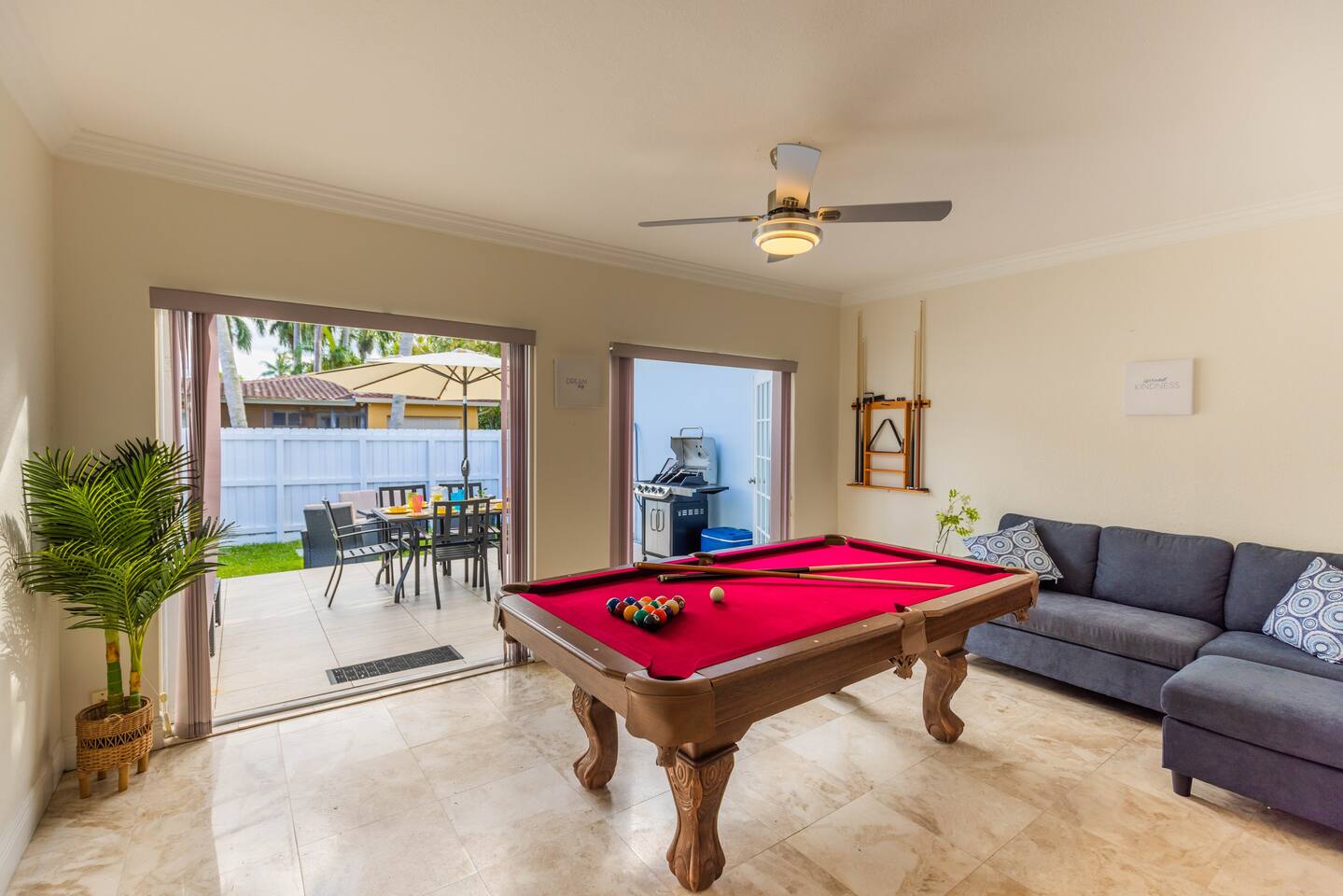 The Florida Room sits off the Living Room. There is direct access to the exquisite patio deck. The Florida Room is a place to have fun and relax. With a large Pool table, games (Monopoly, UNO, playing cards), pull out L-shaped sofa bed and two double doors