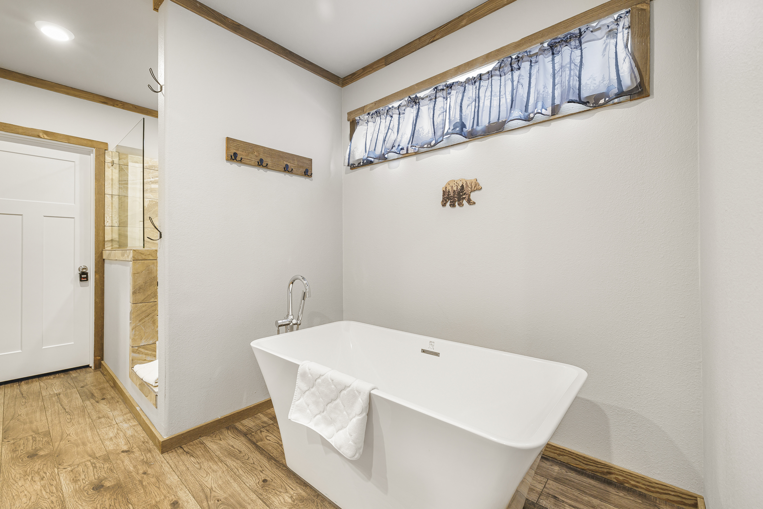 Private primary bathroom with soaking tub and walk in shower