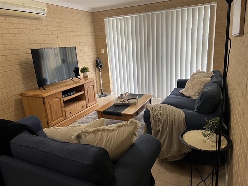 Comfortable lounge / tv area with access to the rear outdoor area