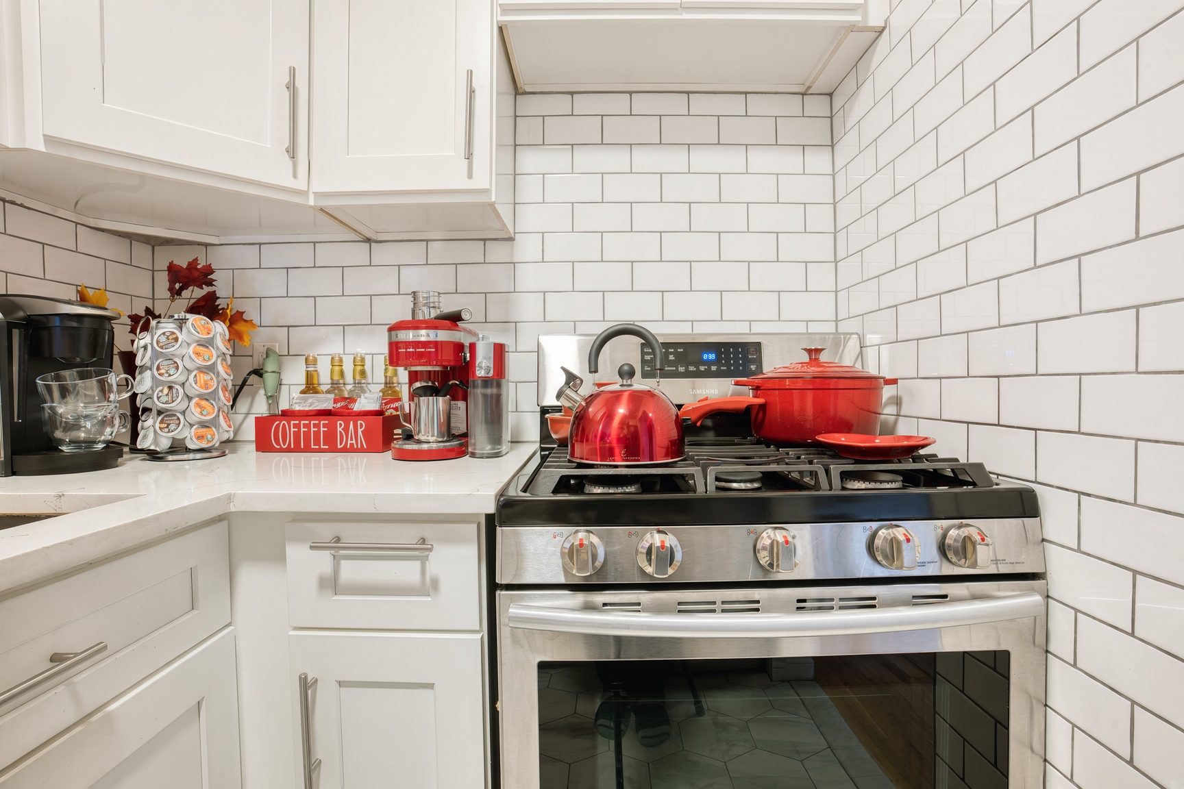 Fully stocked kitchen with stainless steel appliances.