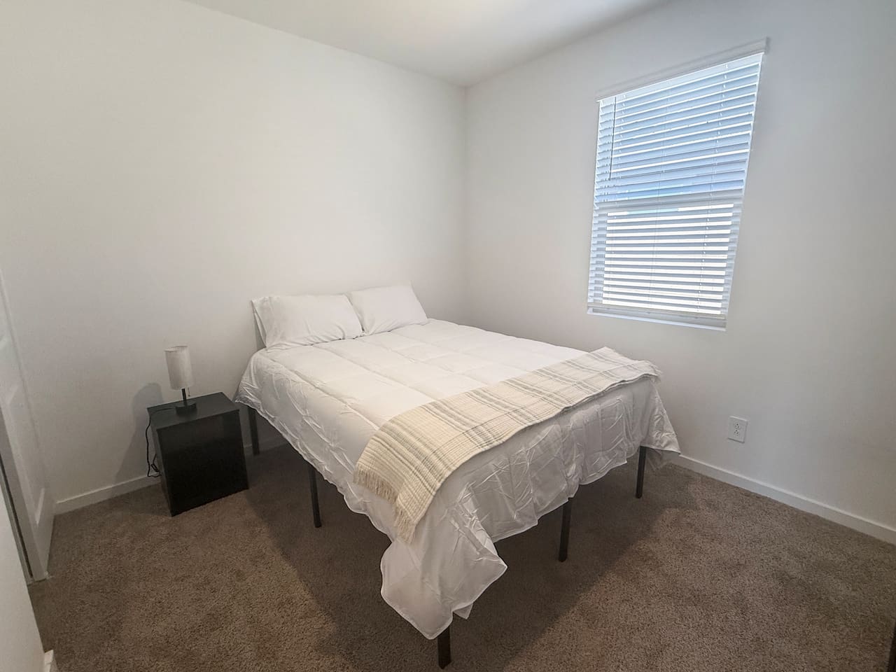 Bedroom with bed, nightstand, and window