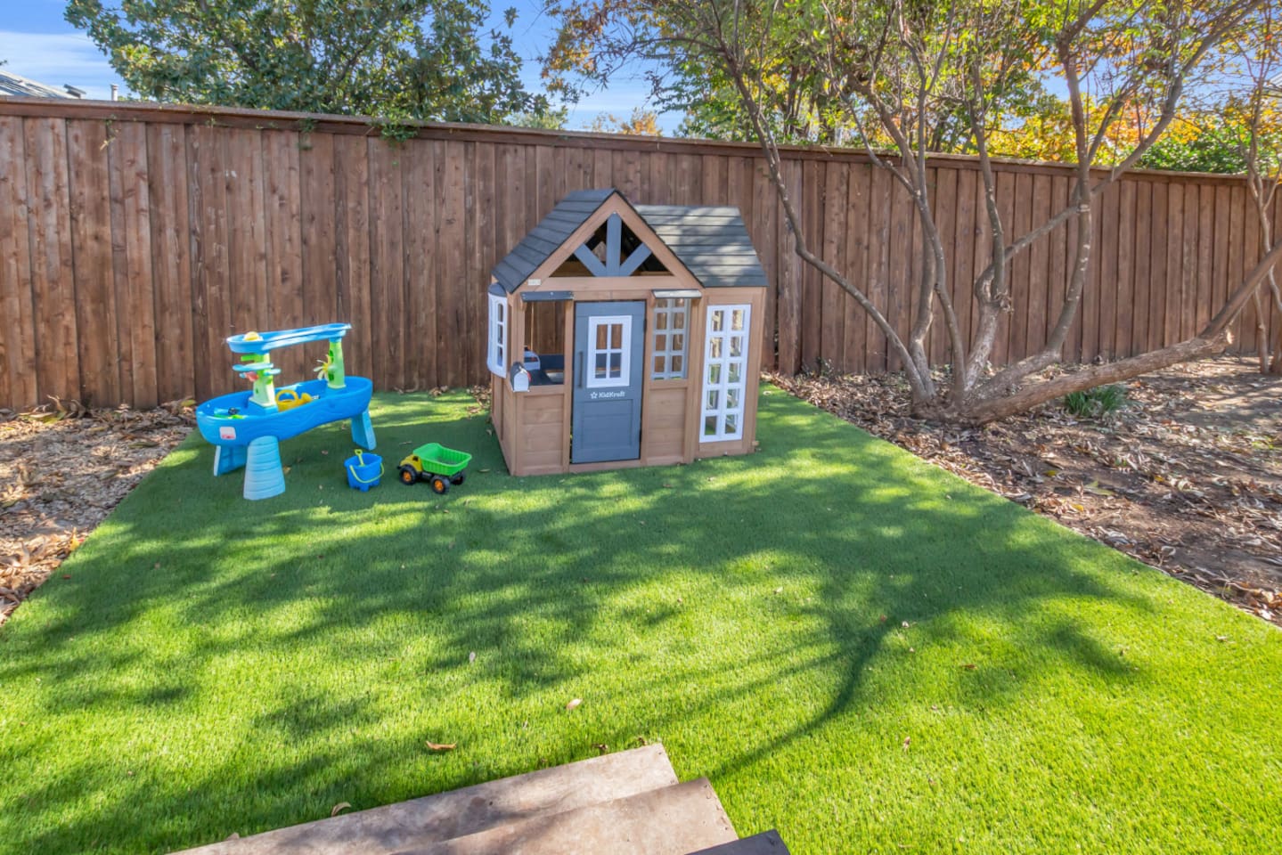 A dedicated kids’ corner with a full playhouse setup, interactive water table, and sensory stepping stones—designed to keep children happy while adults relax nearby.