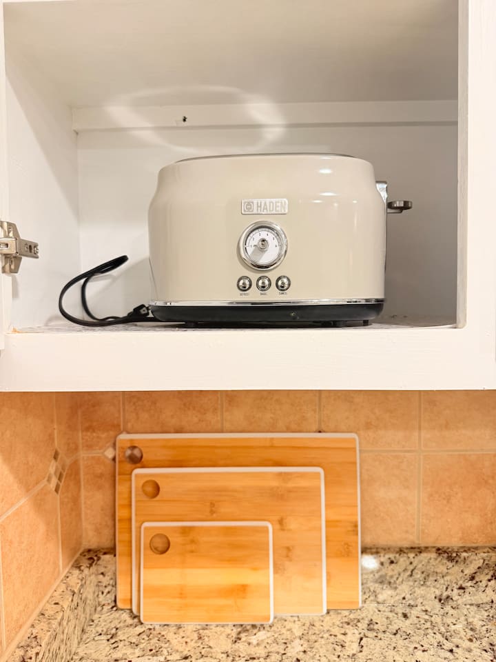 Organized kitchen drawers and shelves keep essentials like cookware, cutting boards, and utensils easily accessible. 