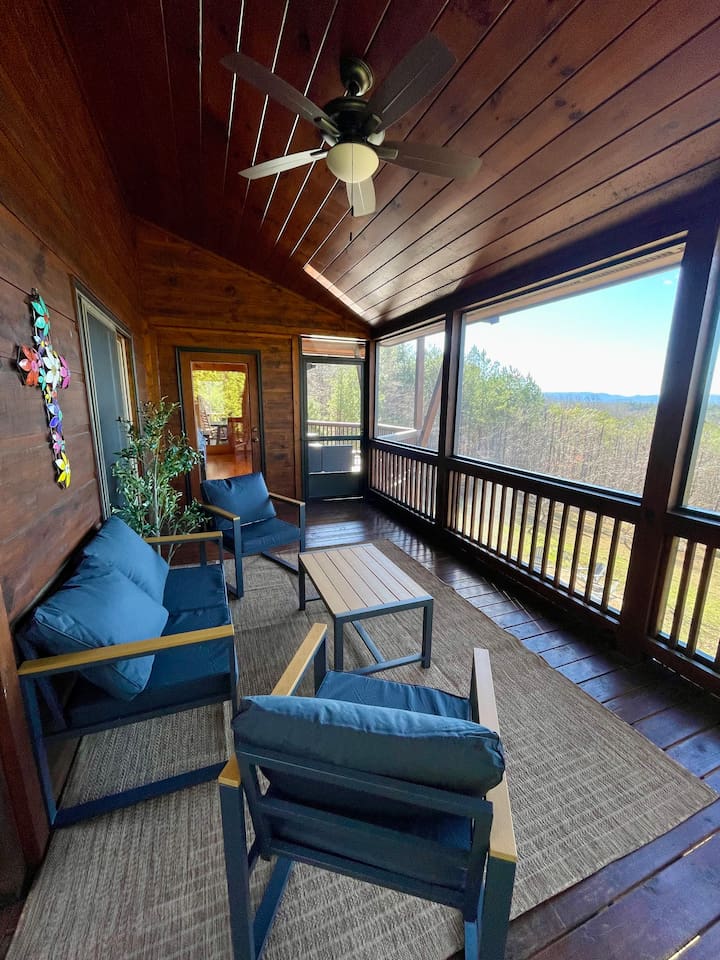Mountain views from the wrap-around porch, especially the screened in porch in the back with comfy cozy outdoor furniture. 