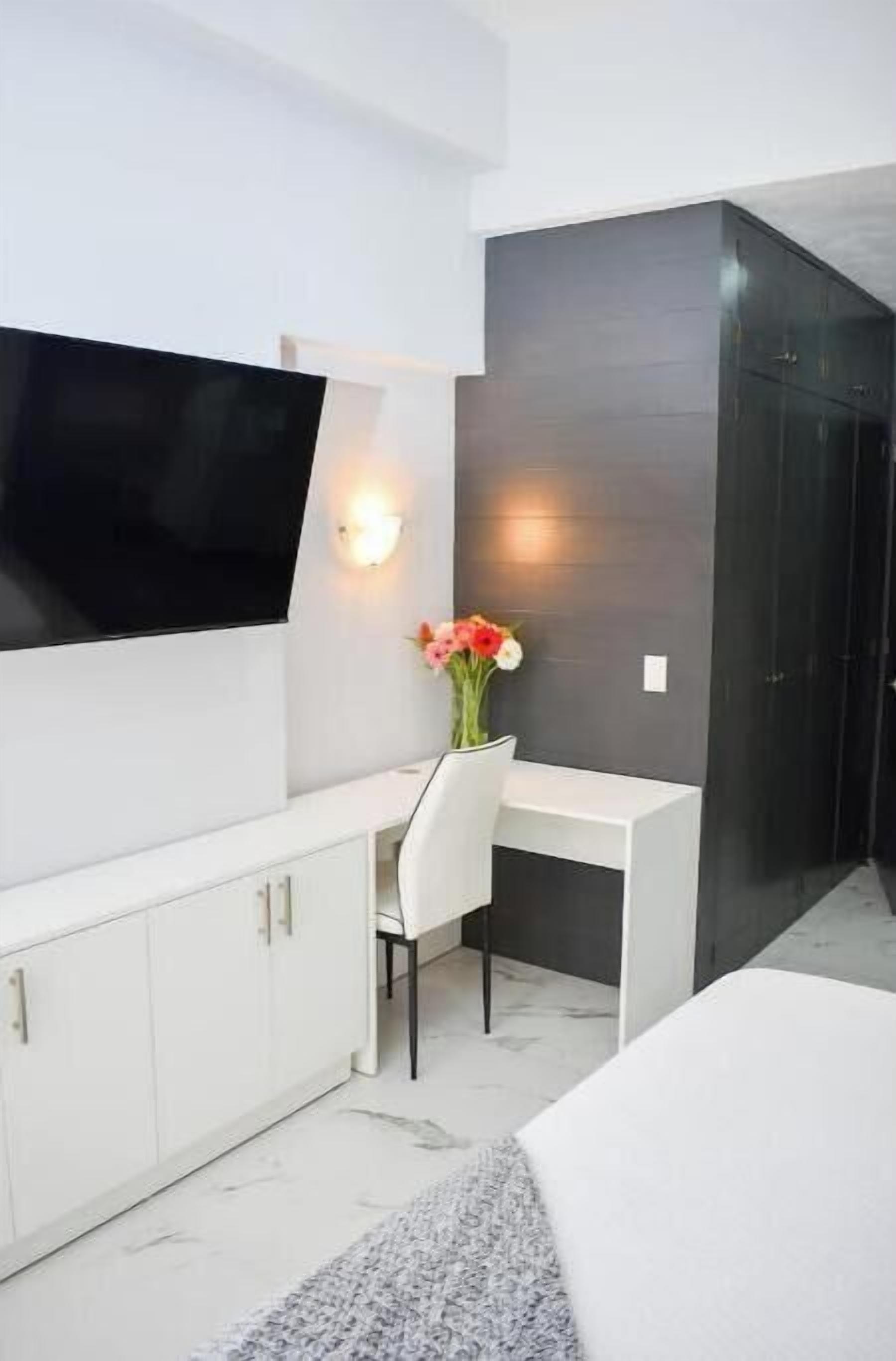 Master Bedroom with office area, ample closet and large Smart TV