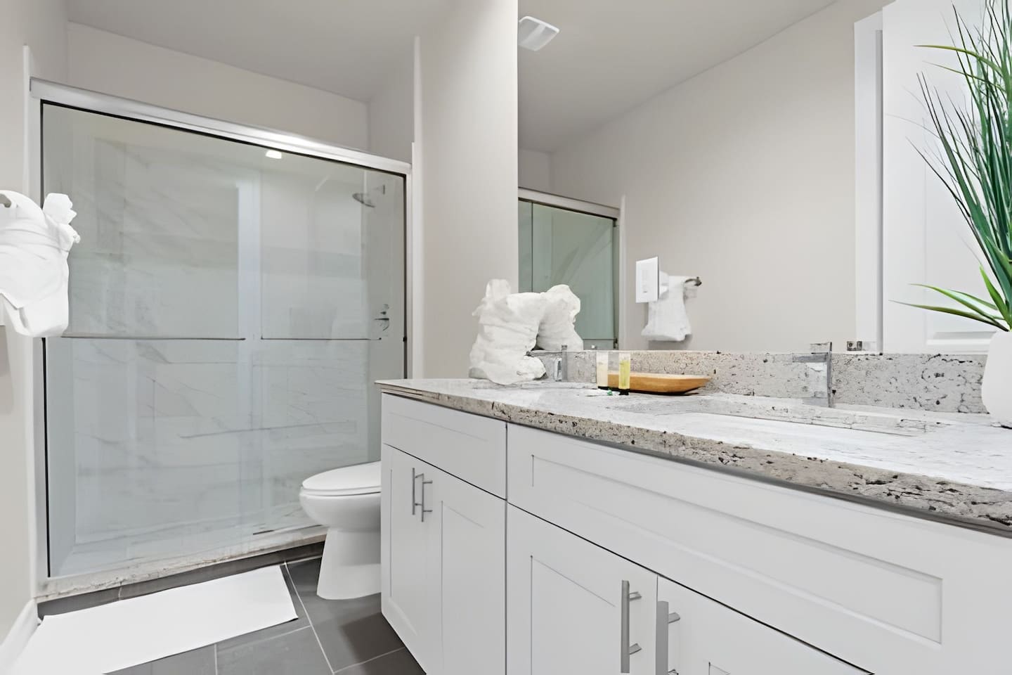 Enjoy a spacious, well-lit bathroom with sleek, contemporary design.