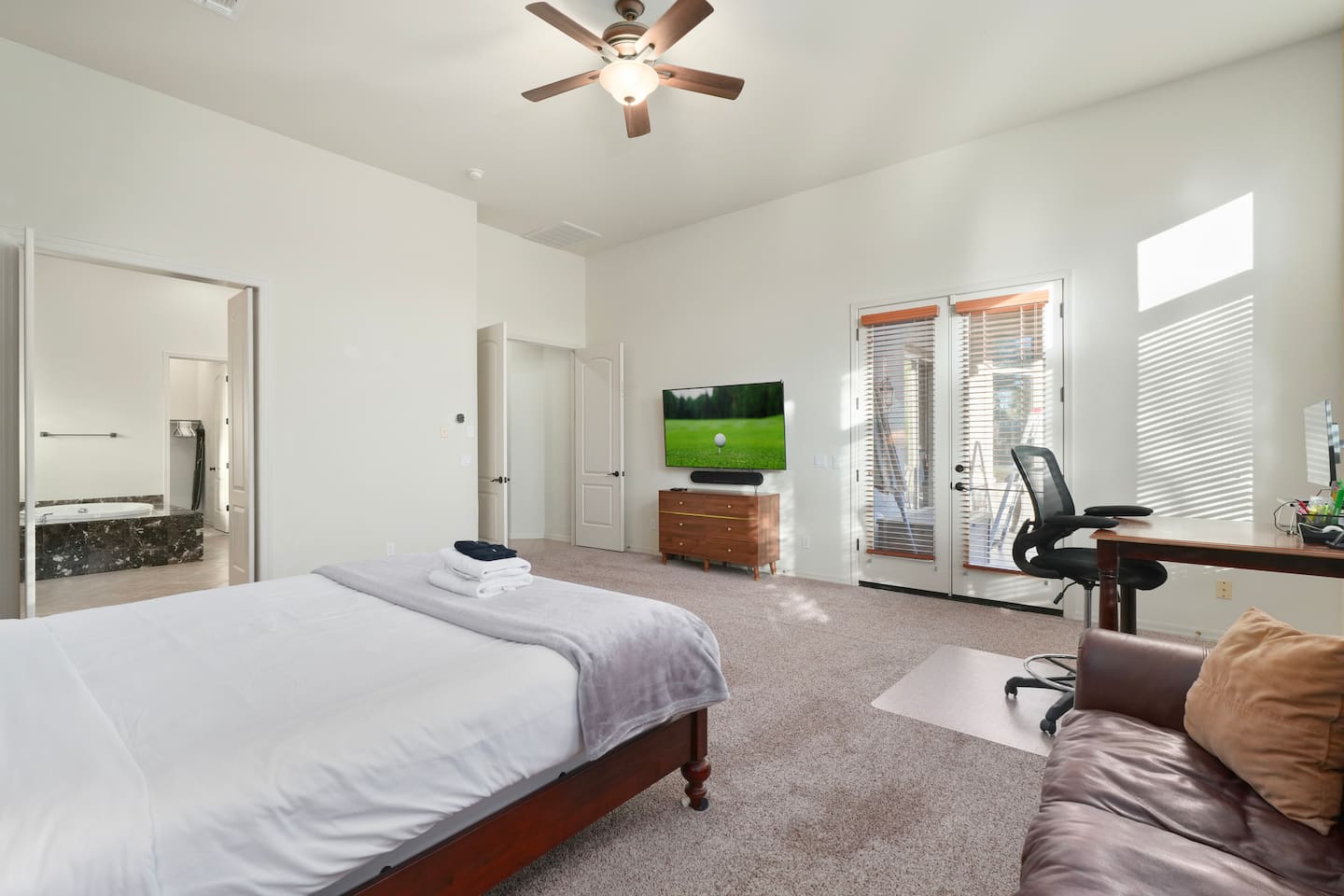 Wide-angle view of the primary suite highlighting its generous layout