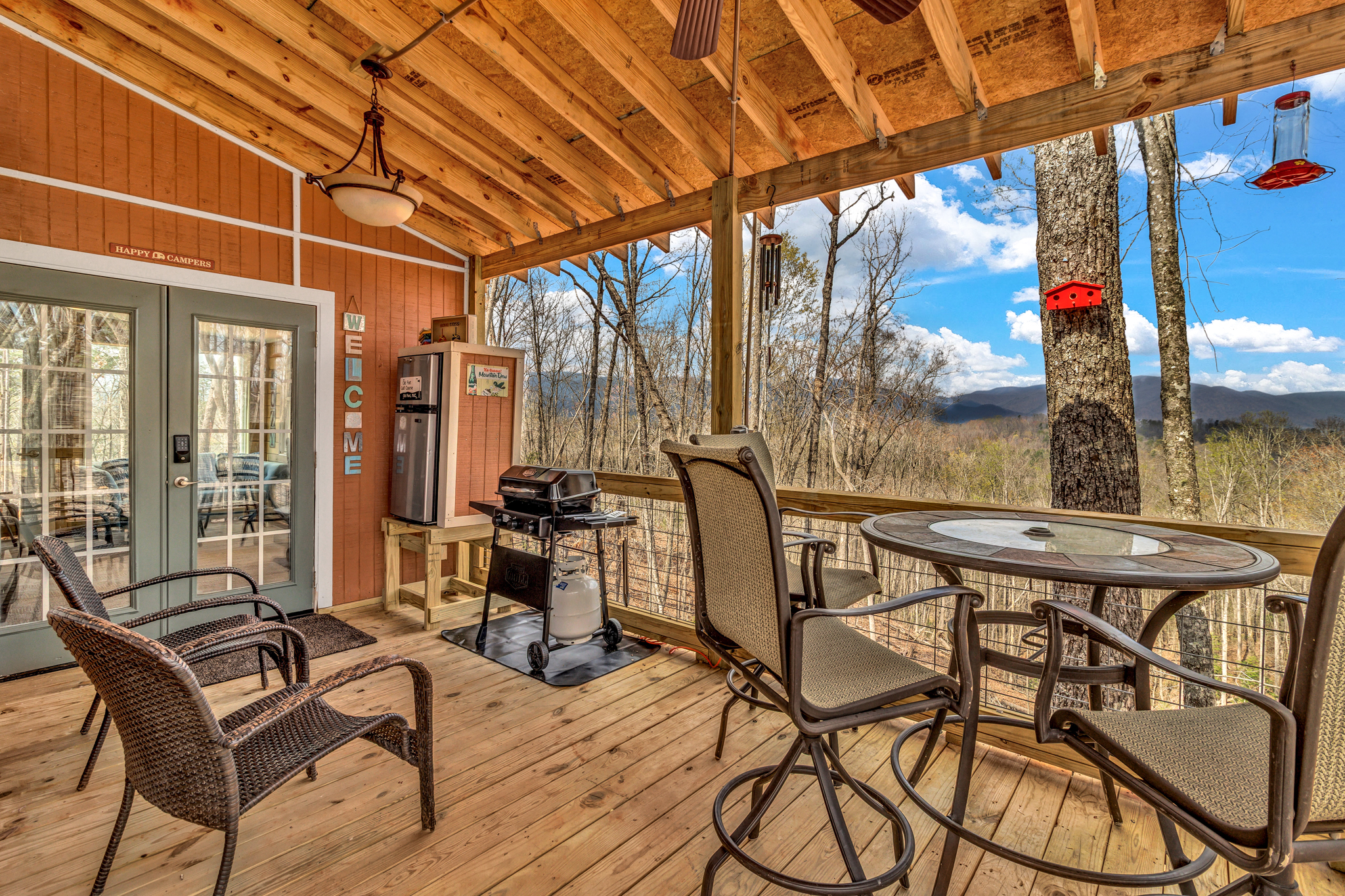 Deck with seating, Propane Grill, and mini fridge.
