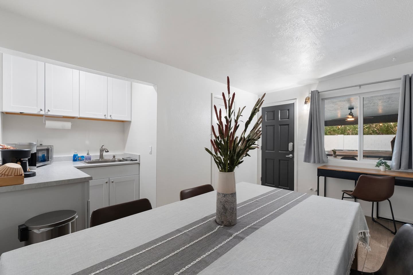 Located just off the entryway and near the workspace, this second dining area adds flexibility for group gatherings or quiet moments.

