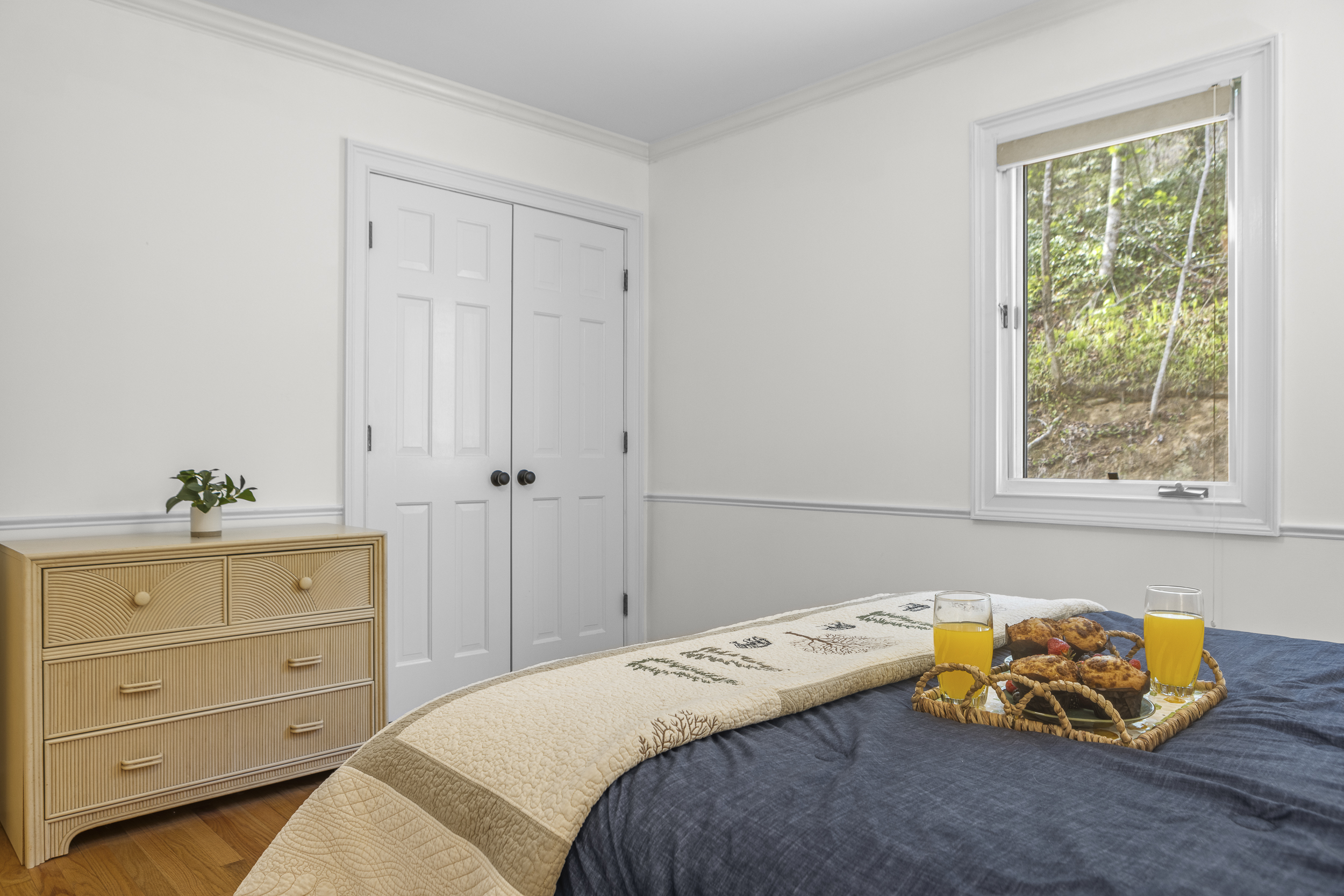 Queen Bedroom 2: Bright space with inviting decor, perfect for restful nights and breakfast in bed!