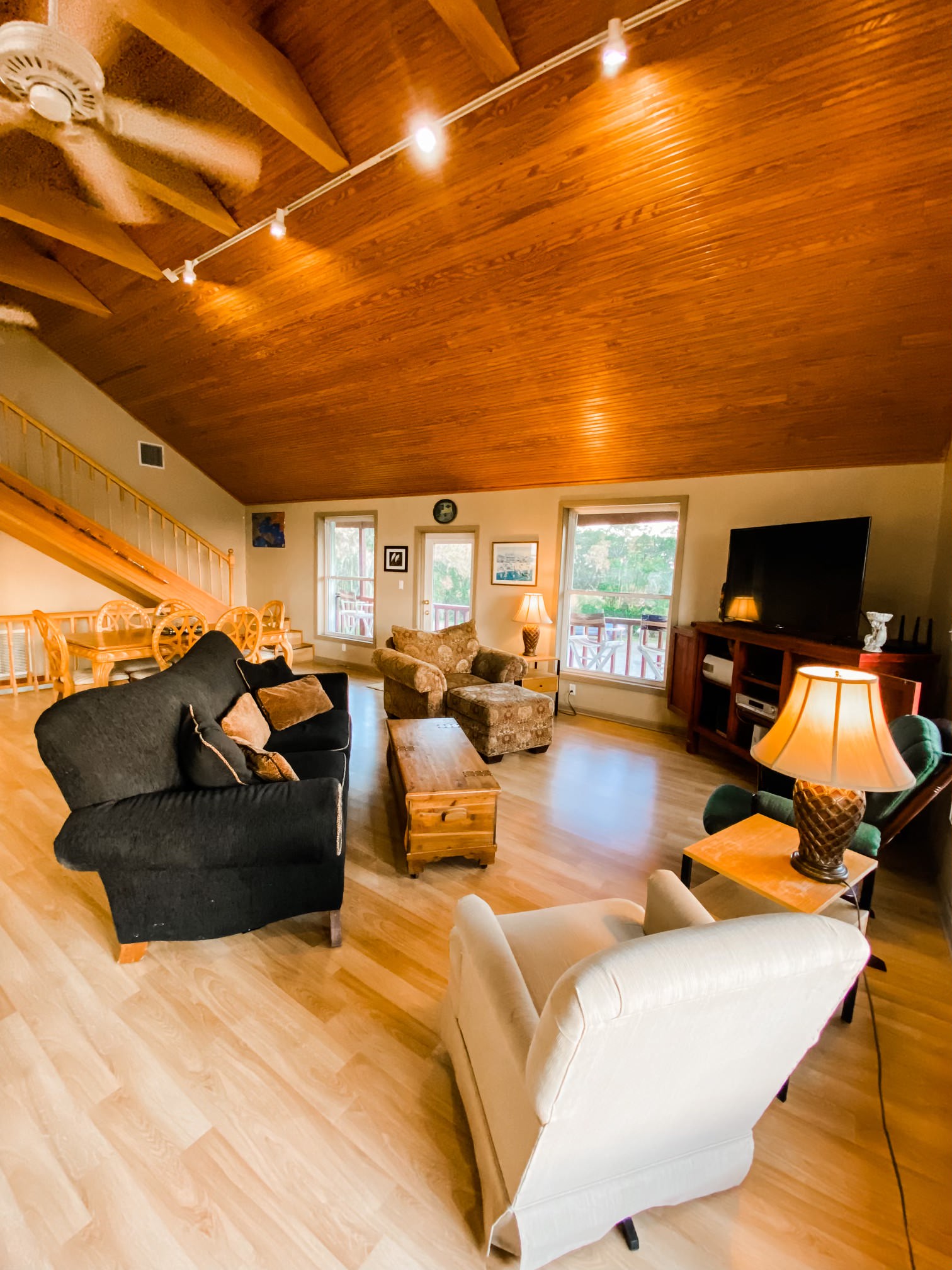 Living room with stairs in background leading to loft on 3rd floor.