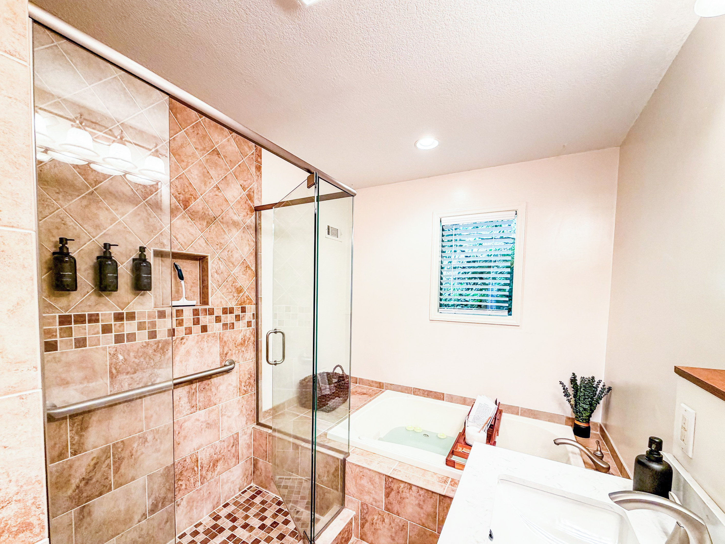 Indulge in a spa-like retreat within the master en-suite bathroom, featuring a beautifully tiled shower and a relaxing whirlpool tub for ultimate rejuvenation.