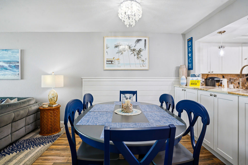 Bright, coastal-inspired dining area in a beach condo, perfect for family meals and relaxed gatherings during your coastal getaway