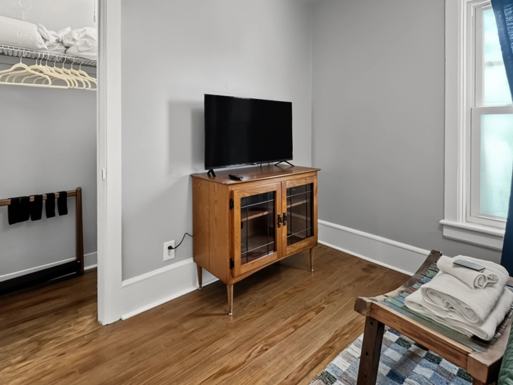 Walk-in closet and TV in the middle bedroom