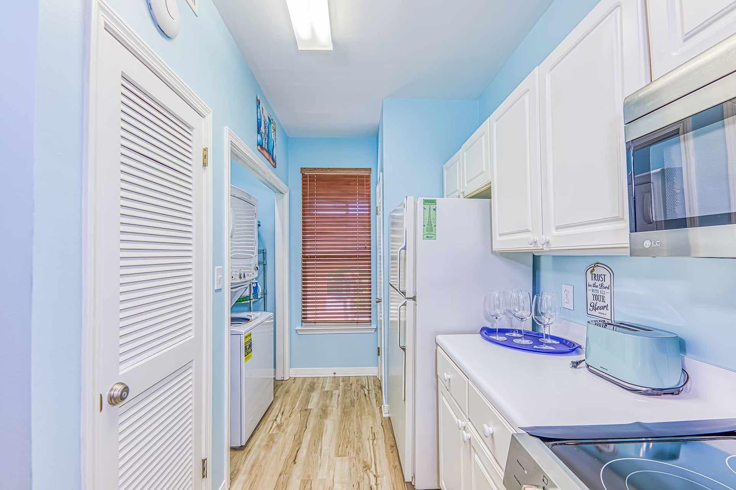 Charming Kitchen: Bright blue walls and modern amenities make cooking a delight!