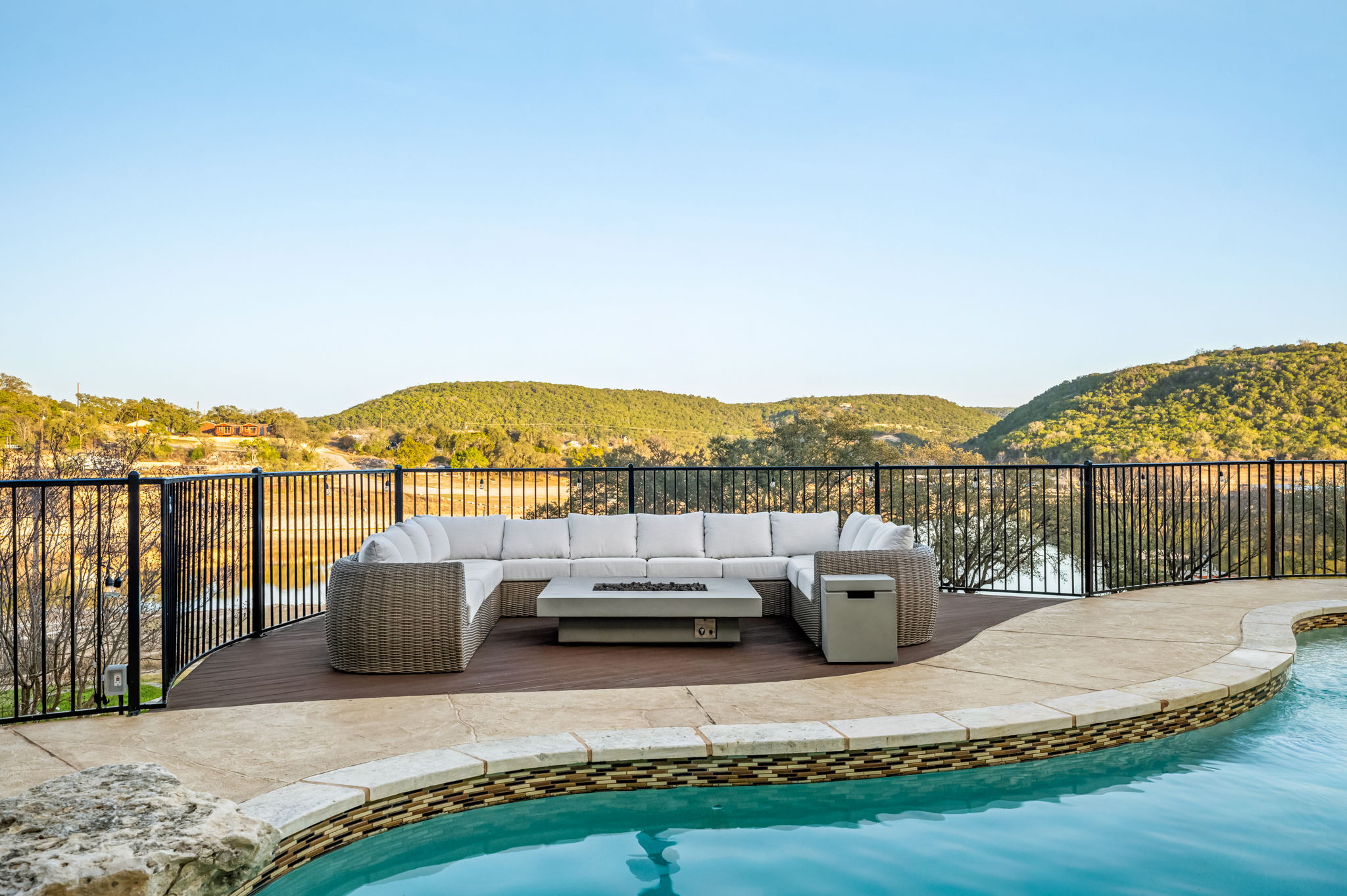Elevated poolside lounge with comfortable outdoor seating and sweeping lake views.