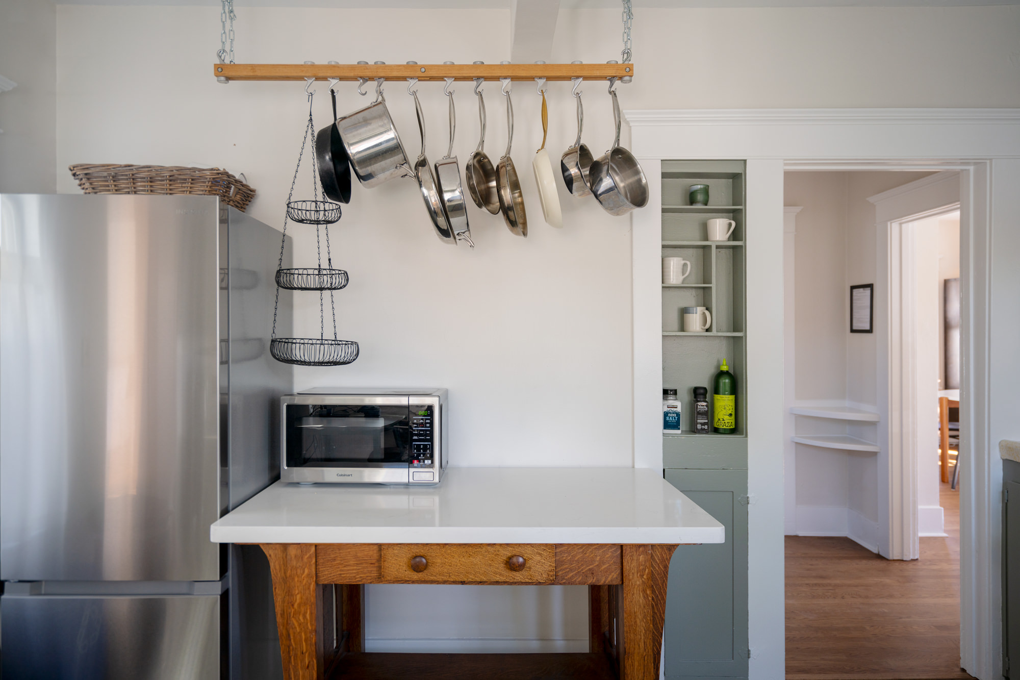 The full kitchen includes pots and pans and a microwave along with a range/oven and coffeemaker.