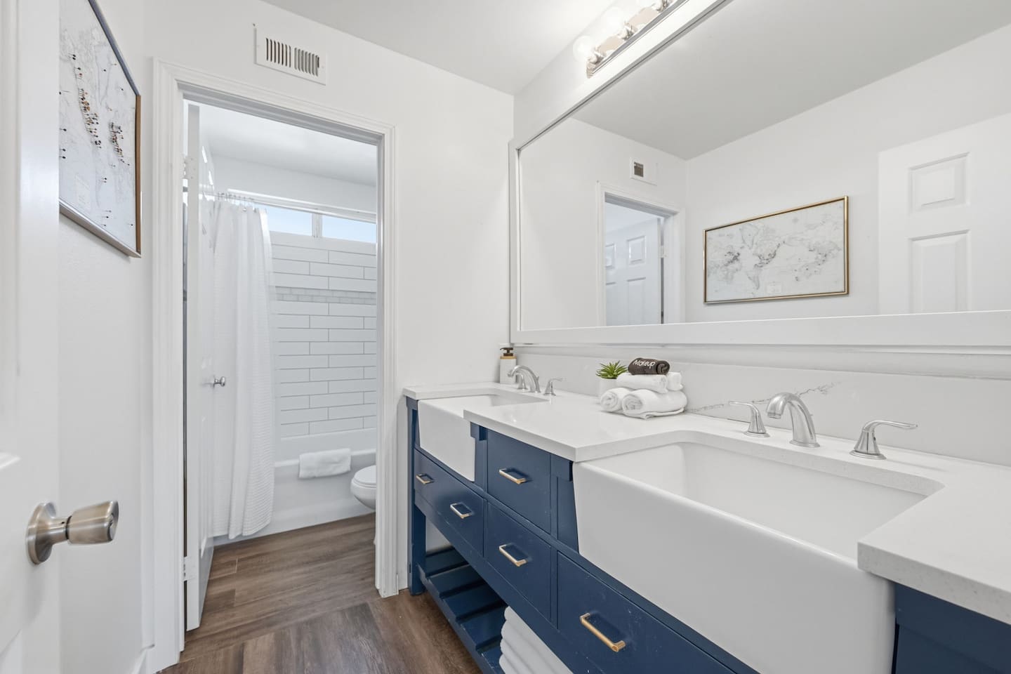 Full bathroom with double vanity, shower + bath tub combo, and modern fixtures. Complimentary toiletries included for all guests.