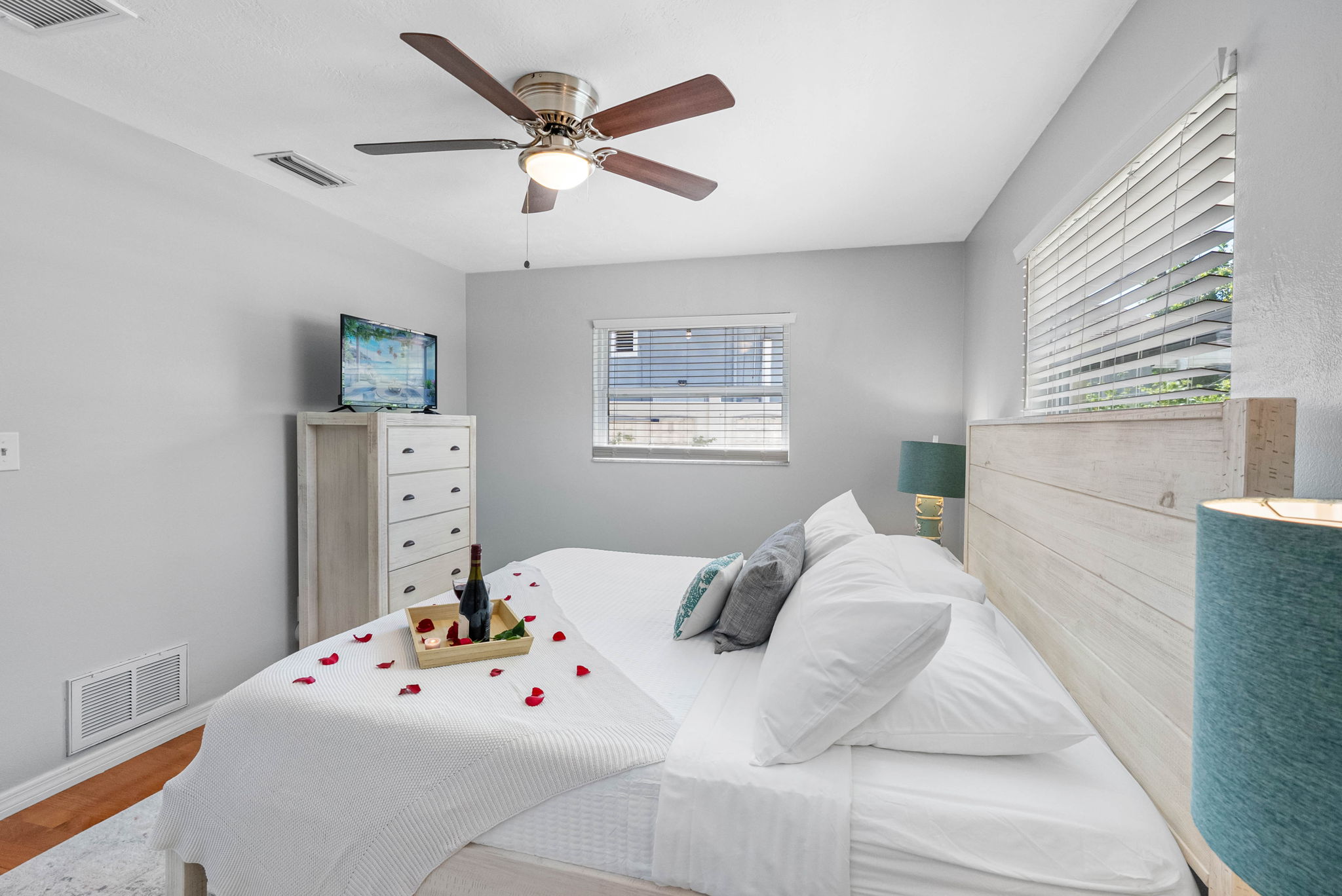 This dreamy bedroom sets the tone for a perfect couple’s escape—complete with soft lighting, plush pillows, and thoughtful romantic touches like rose petals and wine to welcome you.