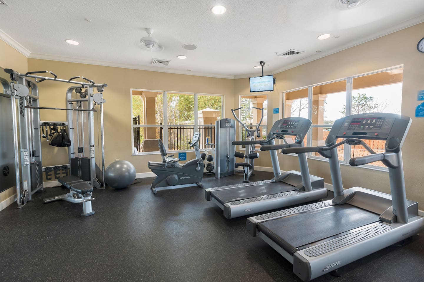 Fitness center with treadmills, machines, and free weights.

