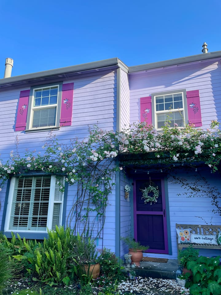 Charming front yard with a peaceful fountain and roses that bloom beautifully in April and May.