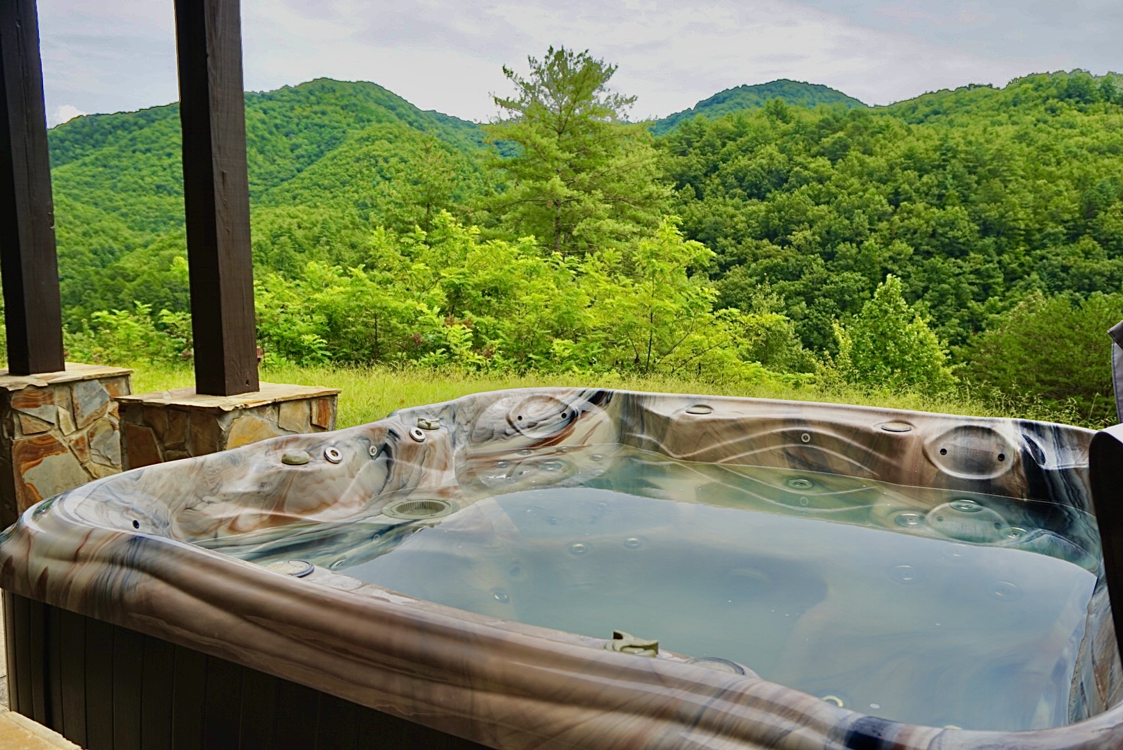 Outdoor Retreat: Soak in the hot tub with stunning mountain views—your perfect nature escape!
