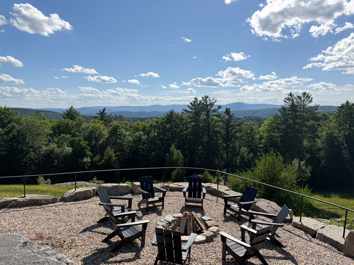 The tavern terrace fire pit in summer with blue sky over the Berkshires valley &mdash; Sunset Falls