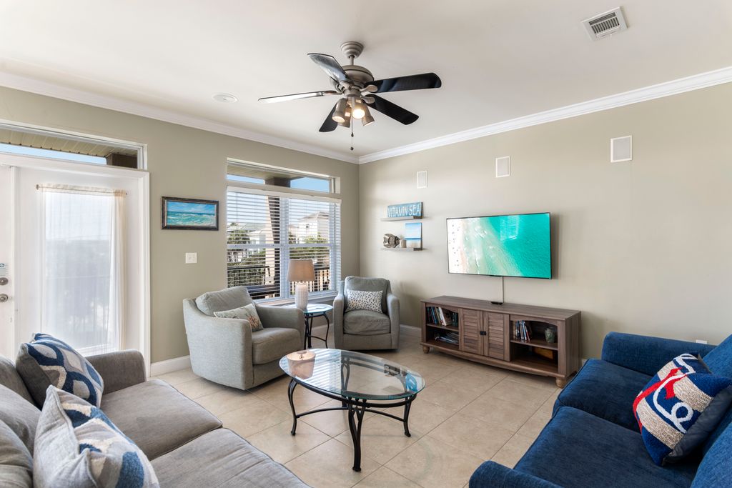 Second Floor: Living Area – Modern design with comfortable couch, additional seating, TV, and center table.