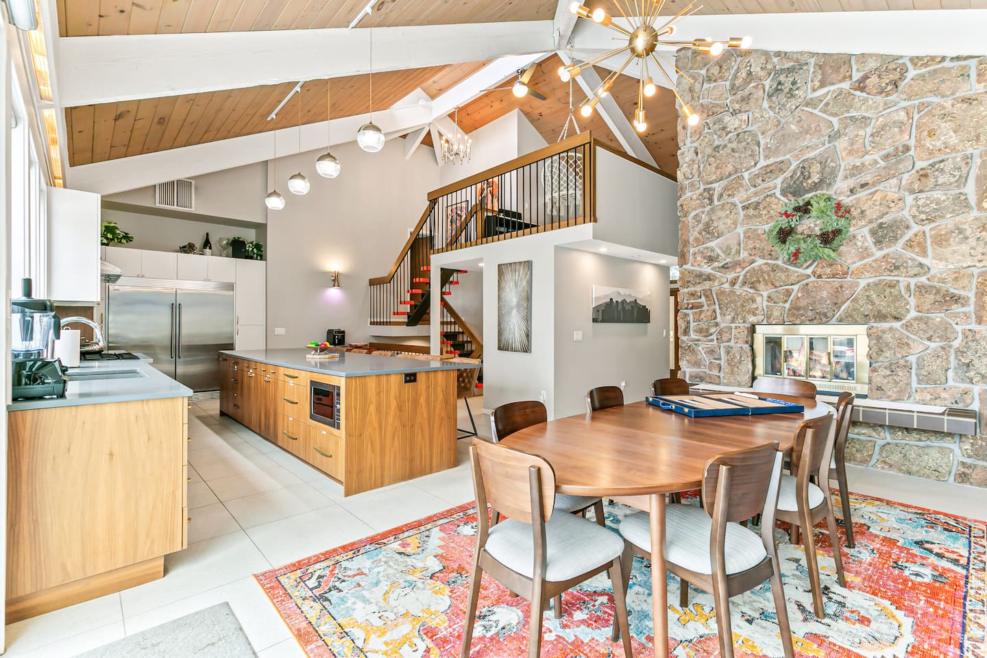 The dining area comfortably seats nine guests, featuring an expandable table and a two-sided fireplace. Its proximity to the fully equipped kitchen, Living Room 1, and the Back Patio adds convenience to mealtimes and social gatherings.