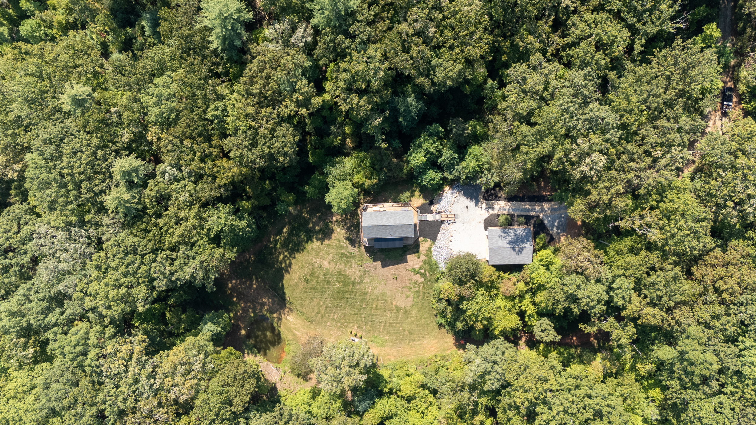 Wide drone shot highlighting Heart Ridge’s peaceful valley setting on 8 private acres.