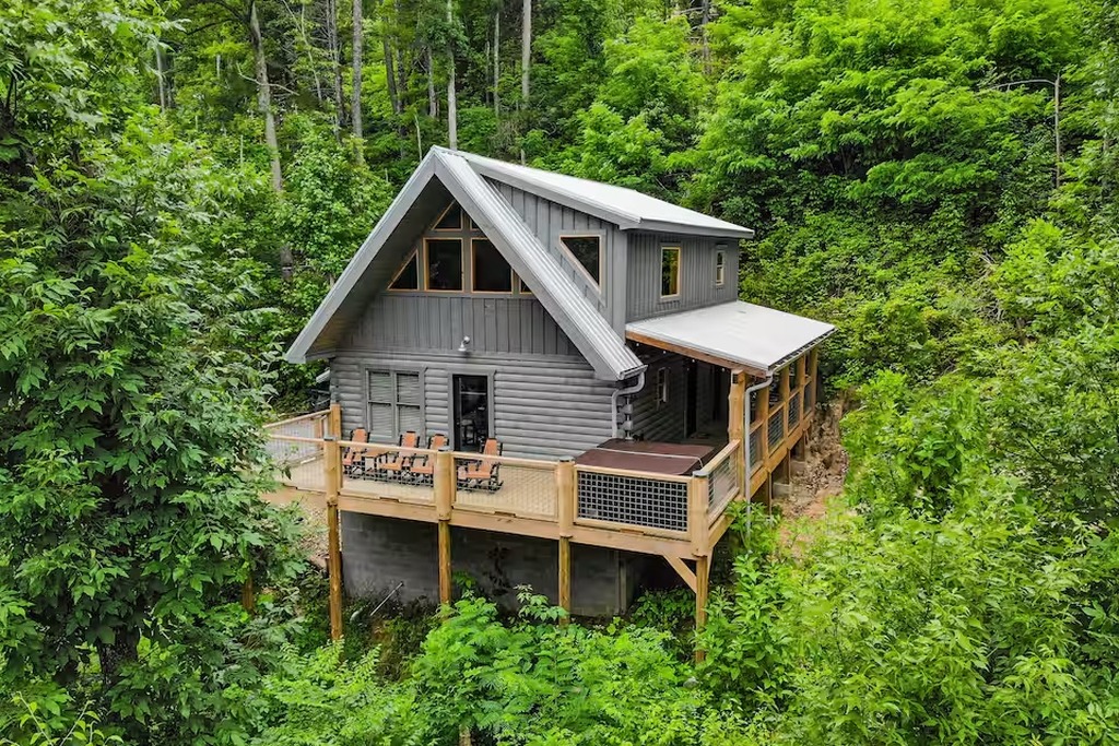 Tucked into the hillside forest just minutes from downtown Gatlinburg, Bear Paws Cabin is a 2-bedroom, 2-bathroom log cabin built for families who want privacy without sacrificing convenience. Your kids will love arriving to this storybook setting in the S
