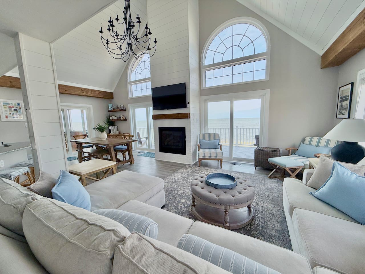 Enjoy the ultimate luxury in this expansive, light-filled living area. With soaring ceilings, a warm fireplace, and breathtaking ocean views, it provides a serene, elegant space perfect for gathering and relaxing.