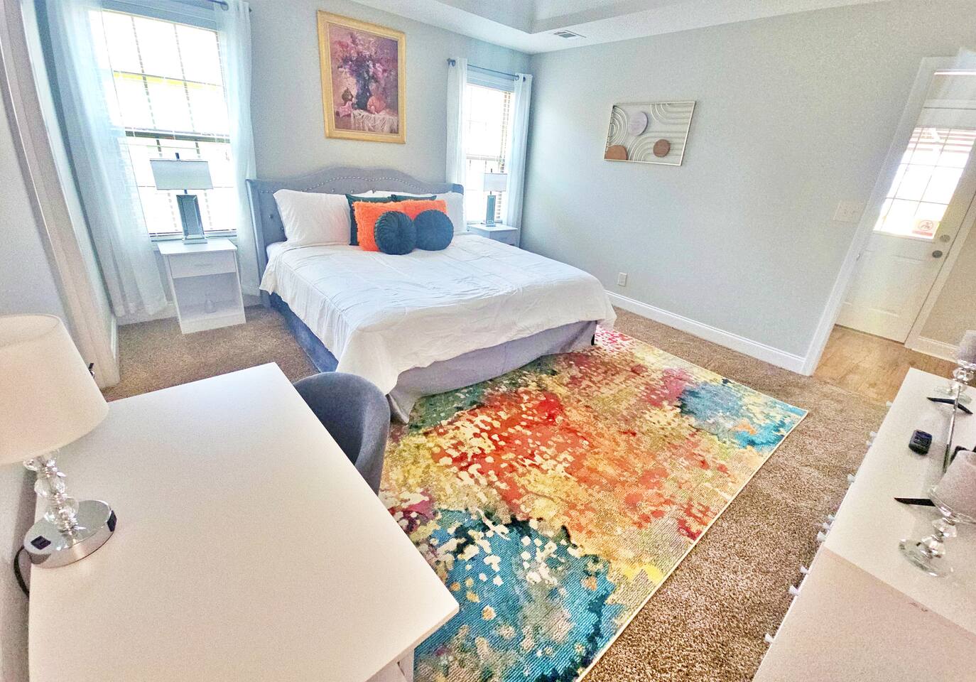 Relax in this hotel-style bedroom. There is a king bed along with a flat-screen smart TV.