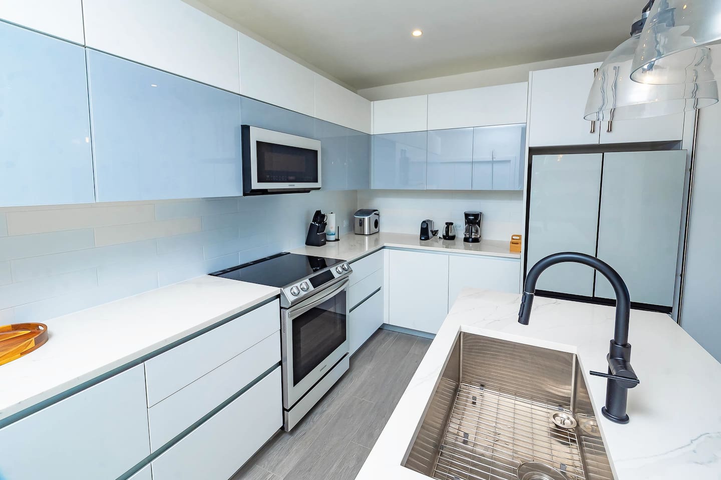 Full kitchen including oven range, induction stove, full size fridge/freezer, dishwasher, microwave, coffee machine, nespresso machine, kettle, ice machine.