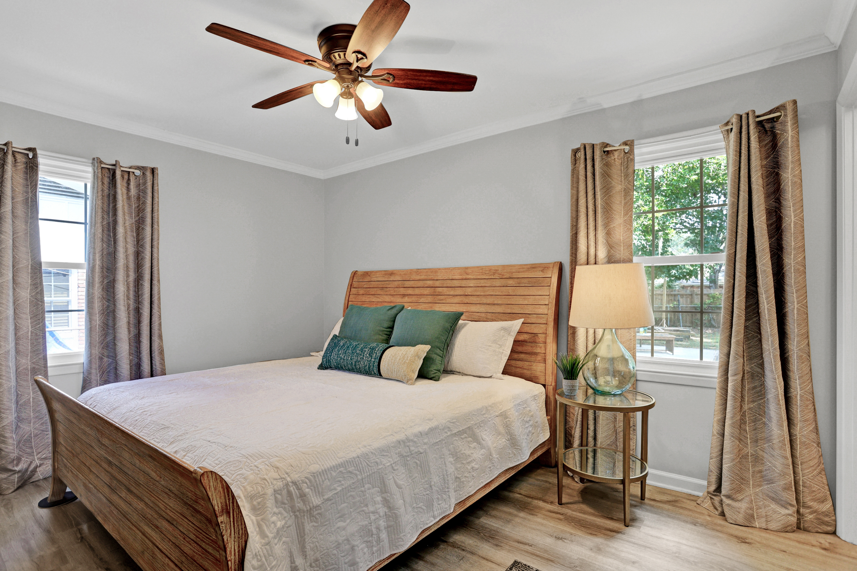 Rest easy in the serene primary bedroom featuring a plush king bed, cozy linens, and a peaceful retreat after a day of exploring.