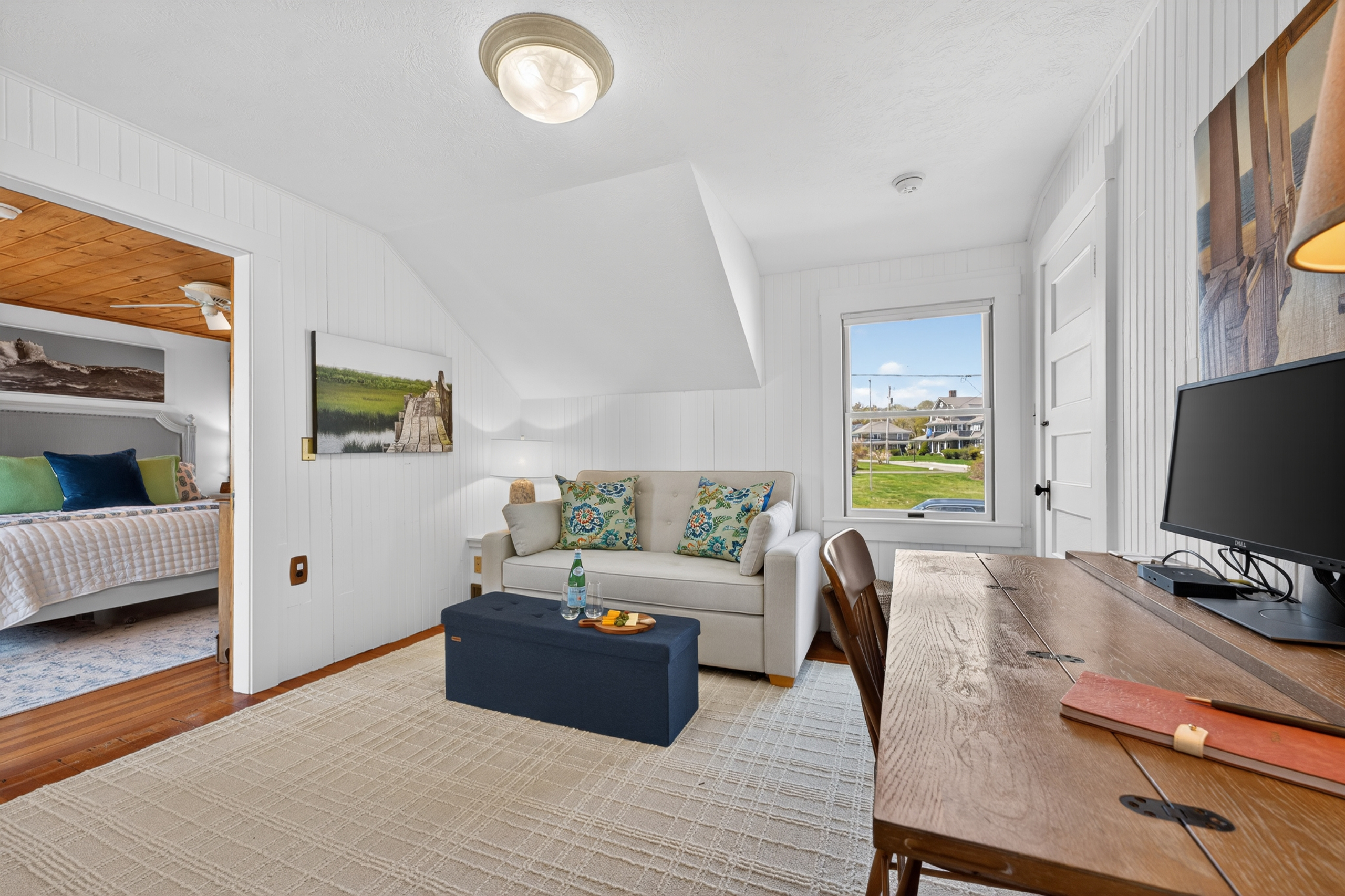 Welcome to our first upstairs bedroom! Featuring an extra pull-out sofa and a work space just for you!