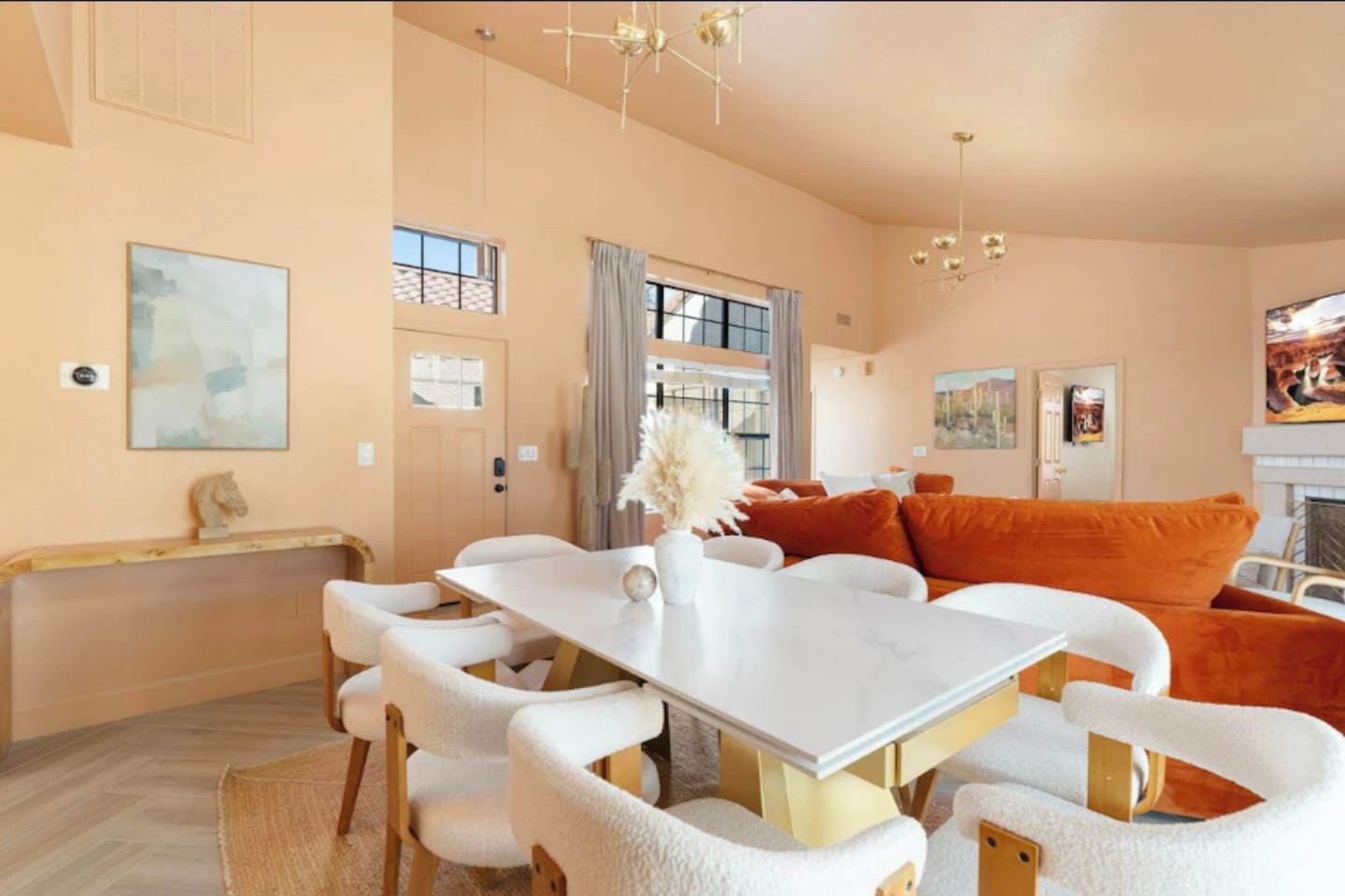 Sunlit open-concept living with marble dining, hardwood floors, and layered seating for every mood.