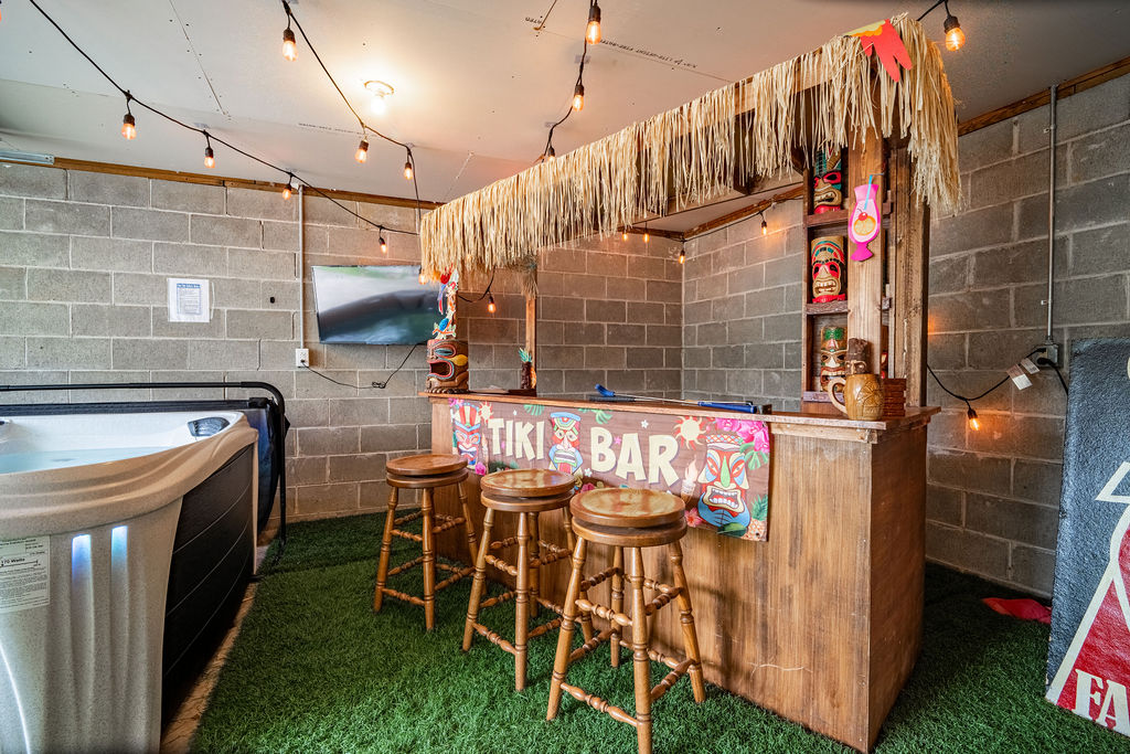 Pull up a stool at the custom Tiki bar! The perfect backdrop for family game nights, enjoying a cold drink, and making lasting vacation memories. We provide Corn Hole, golf putting, and plenty of games along with a brand new jacuzzi hot tub.