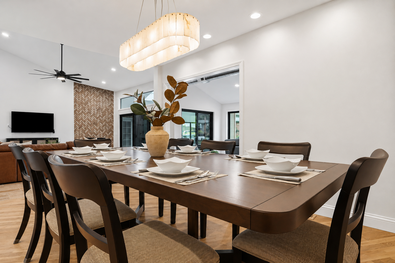 Elegant dining area with a large table, modern seating, and bright open layout. Stylish, minimalist space perfect for family meals and entertaining.