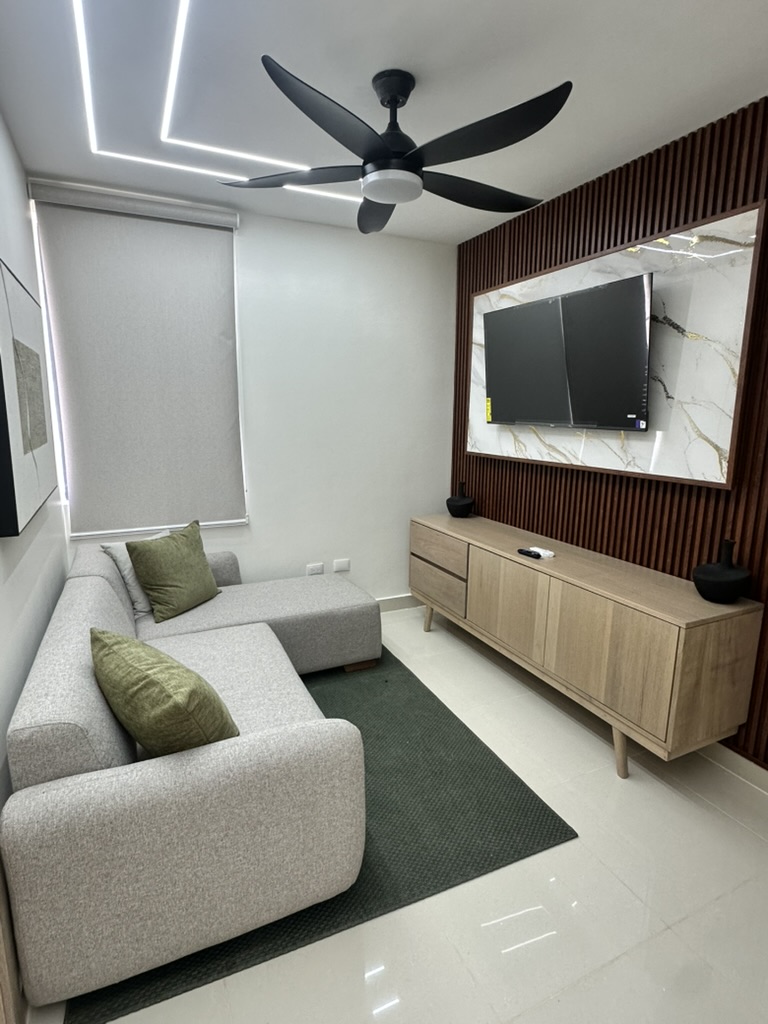 Cozy TV lounge area with a comfy sofa—perfect for movie nights, relaxing, or hooking up your own gaming console. 🎮🍿📺