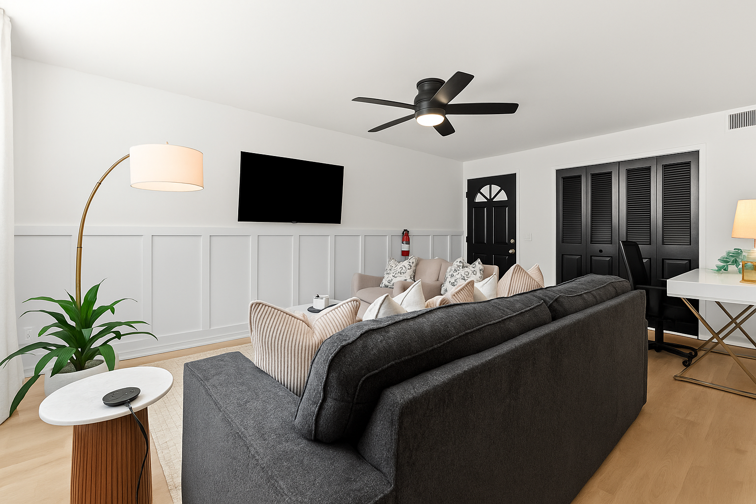 Comfort meets style in this thoughtfully designed living room, complete with streaming-ready entertainment and a calming atmosphere.