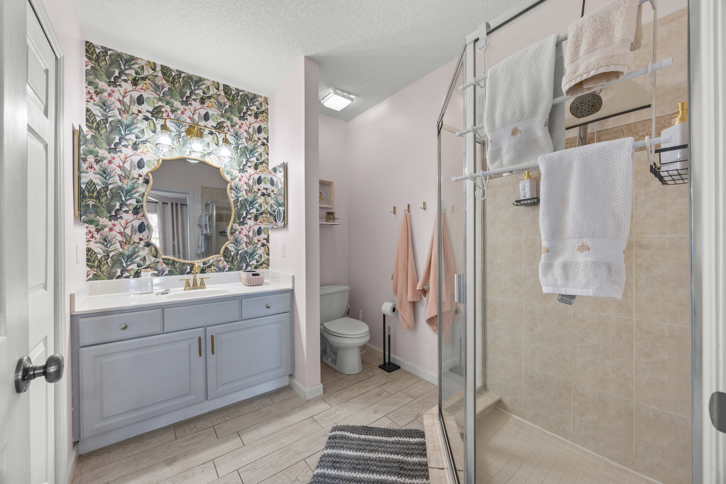 Modern ensuite bathroom with a roomy glass shower and modern accents.