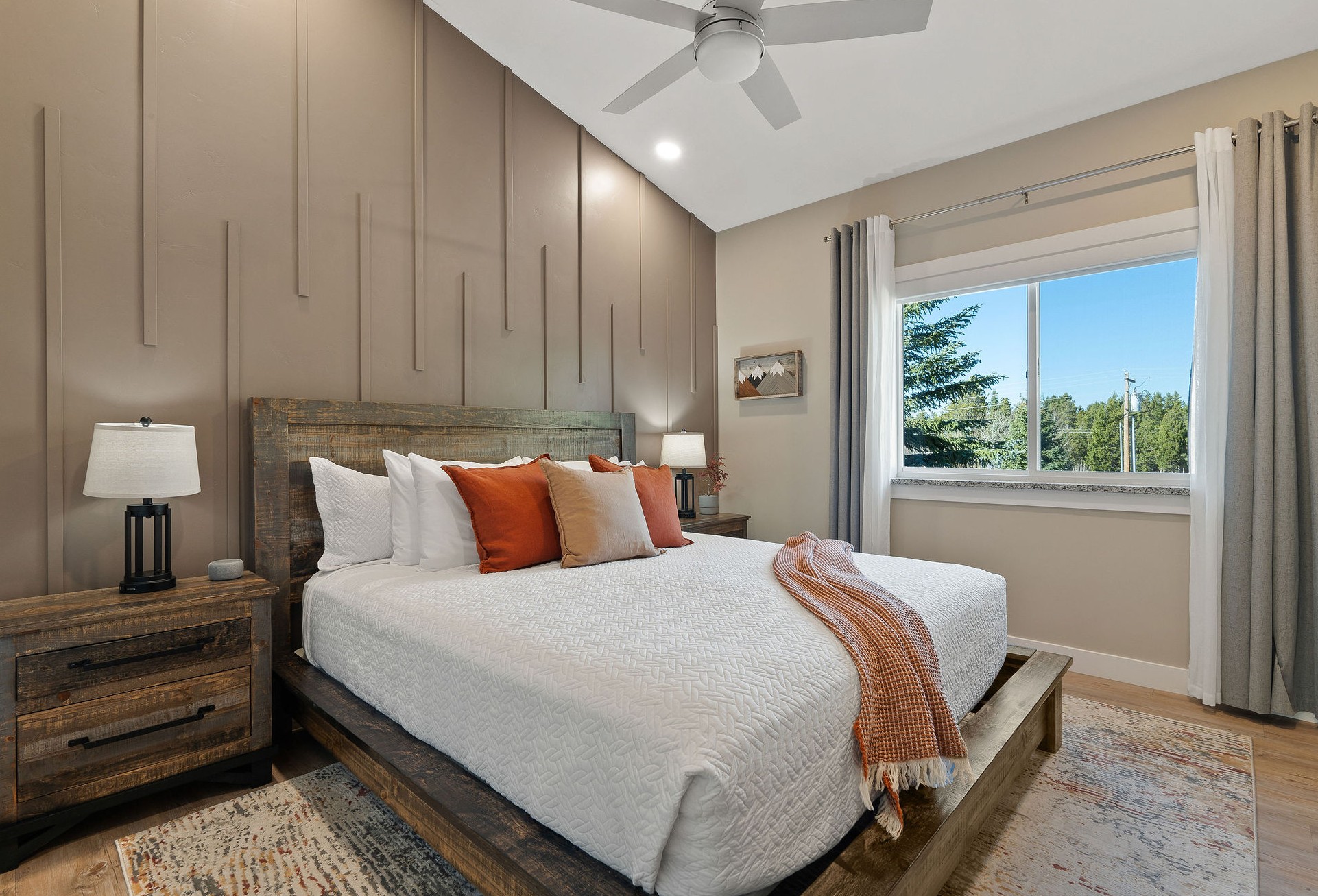 The Prismatic/Excelsior bedroom features a spacious king bed and is located across the hall from the second bathroom. Both bedrooms include sheer window coverings for daylight, along with room-darkening shades and curtains for a good night’s sleep.