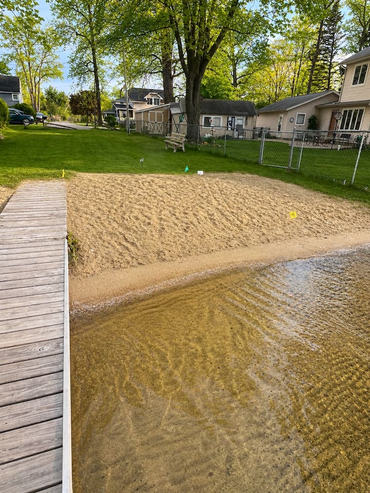 Small beach area next to dock that over looks the Lake. 