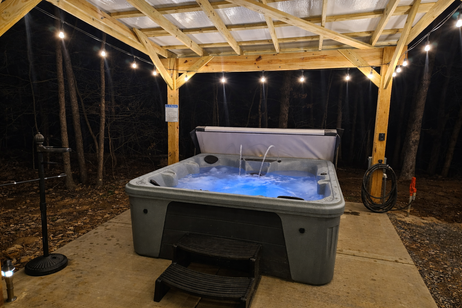 Slip into the warm, bubbling hot tub beneath a covered pavilion and soft string lights—an intimate, romantic escape designed for quiet moments and unforgettable evenings together at Eagle Retr