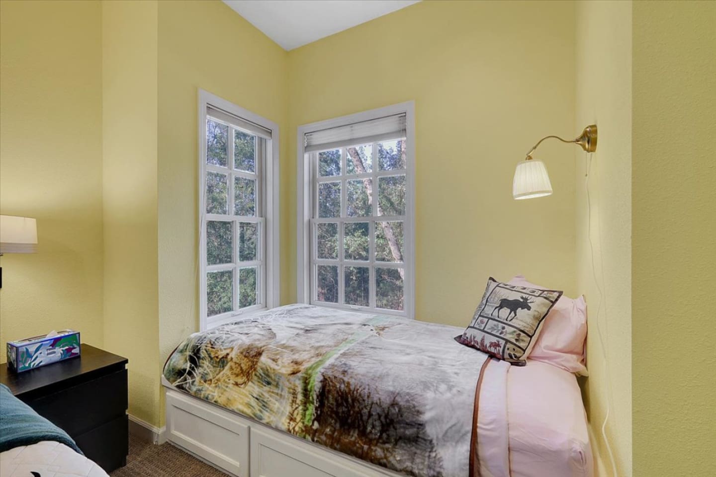 Bedroom 2 with a queen bed, twin bed, and rollaway twin for flexible sleeping space.
