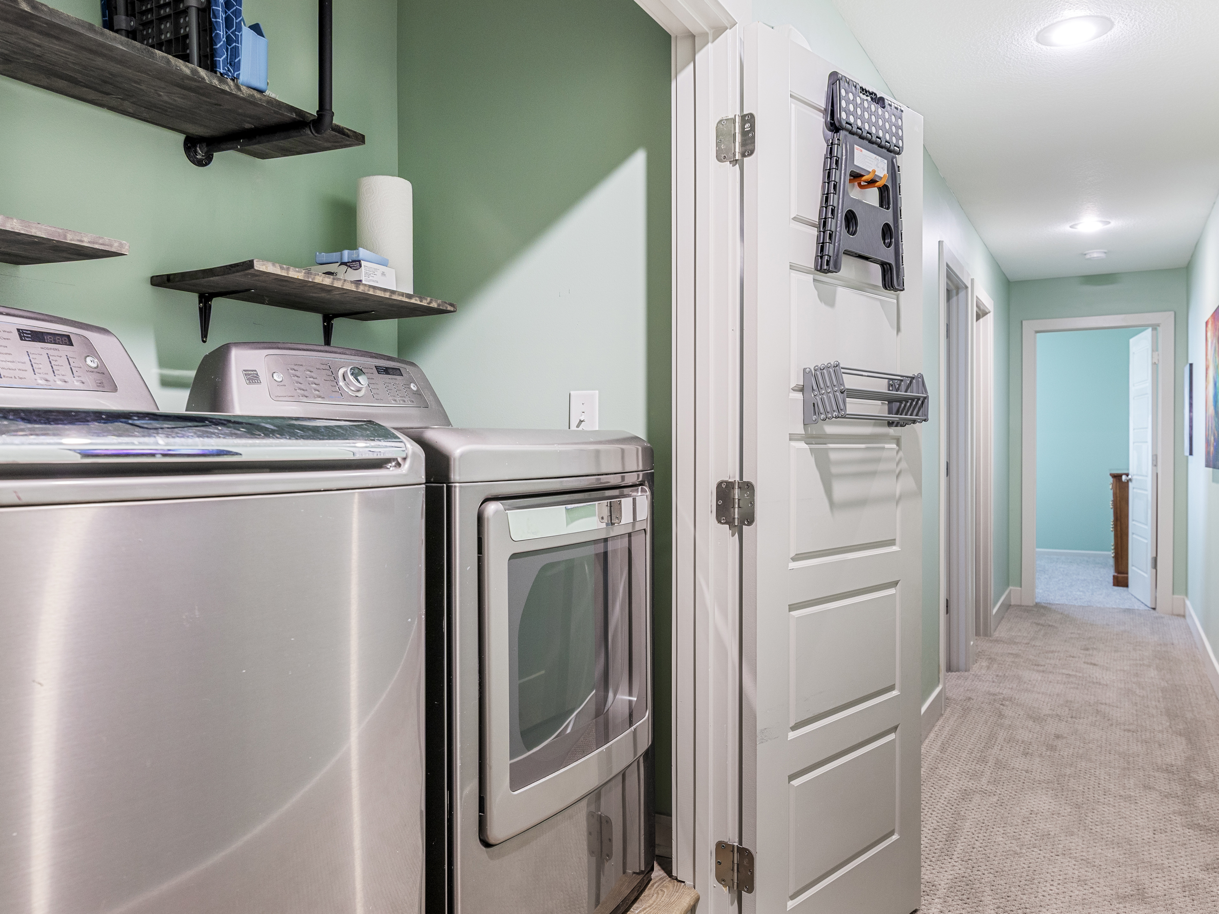 Fully equipped laundry area with a full-size washer and dryer, ironing board, hanging rack, detergent, bleach, and stain remover. Additional cleaning supplies are provided for added convenience during your stay.