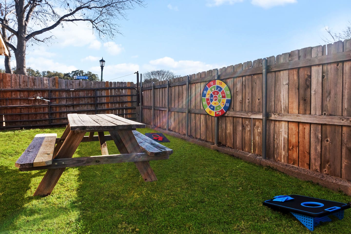 Step into your private backyard retreat—complete with a picnic table, dart board, and cornhole for laid-back fun.