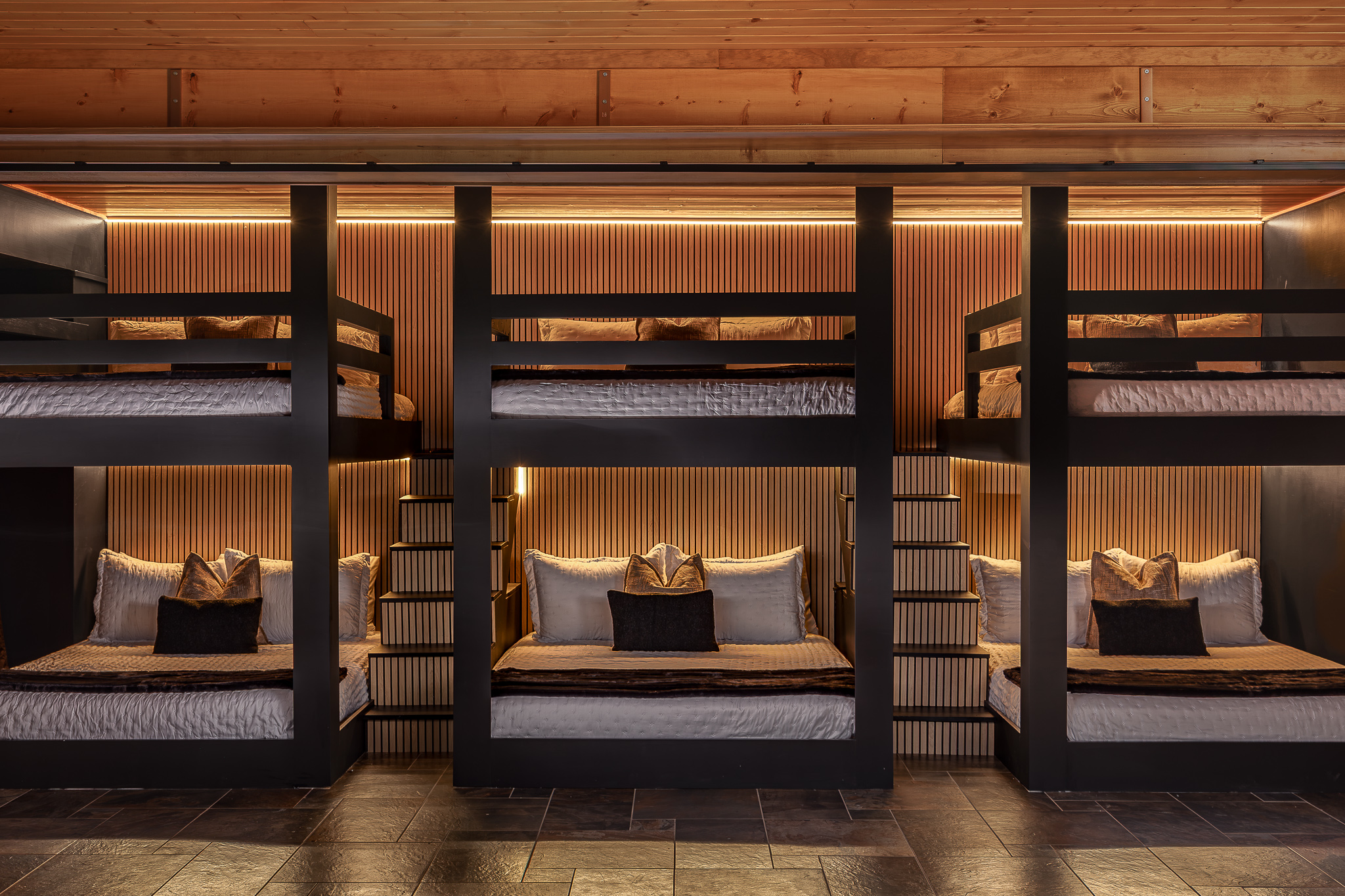 {Bunk Room} Three queen-over-queen bunks create six queen beds in one dramatic, custom sleeping space made for groups.