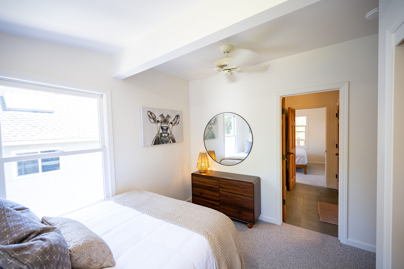 Second bedroom featuring a queen bed with comfortable linens and a quiet, relaxing atmosphere